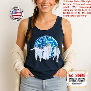 May include: A navy blue tank top featuring a graphic print of five individuals in white clothing standing in front of a glowing blue circular digital grid pattern. The tank top has a round neckline and sleeveless design, showcasing a modern aesthetic.