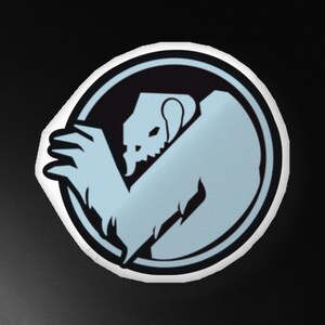 May include: A black and white circular sticker with a light blue monster inside. The monster has a skull-like face and is curled up in a defensive position.