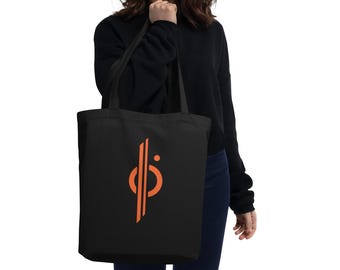 Könnte beinhalten: Eine schwarze Tragetasche mit einem leuchtend orangenen Logo, das ein stilisiertes Symbol mit einem Kreis und Linien zeigt. Die Tasche hat lange Henkel.
