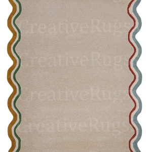 May include: Rectangular rug with a wavy border. The border features a repeating pattern of red, yellow, green, and blue stripes. The rug's central area is a solid beige colour, and the text "Creative Rugs" is faintly visible.