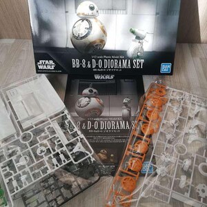 May include: A Star Wars BB-8 & D-O Diorama Set model kit. The box features images of the BB-8 and D-O droids. The kit includes plastic model parts in clear and orange sprues, ready for assembly. The box has the Star Wars logo.
