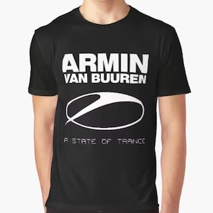 May include: Black graphic t-shirt featuring the text "ARMIN VAN BUUREN" in white block letters above a white oval design. Below the oval, the text "A STATE OF TRANCE" is printed in white.