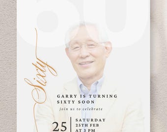 May include: A white invitation card with the number 60 in the background and the word "Sixty" in a cursive font. The invitation includes a photo of a smiling man and text that reads "Garry is turning sixty soon" with the date and time.
