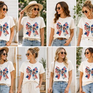 May include: A short-sleeved cream-coloured t-shirt featuring a large graphic of a decorative bow. The bow is composed of various fabric patterns in red, white, and blue, including stars and stripes, creating a patriotic-themed design on the front.