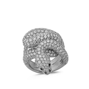 May include: A silver snake ring, densely covered in small, sparkling white gemstones. The snake's head has two small black gemstones for eyes. The ring is a statement piece, with the snake coiled around the finger.