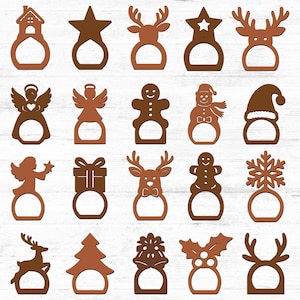 Puede incluir: Colección de servilleteros navideños de madera marrón. Los diseños incluyen una casa, estrella, reno, ángel, hombre de jengibre, muñeco de nieve, regalo, árbol de Navidad, copo de nieve, acebo y gorro de Papá Noel.