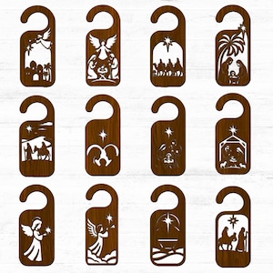 May include: A collection of twelve wooden door hangers with various Christmas-themed cut-out designs. Each hanger features a different nativity scene, angel, or star, all in a warm brown tone. The designs are intricately cut out, creating a decorative effect.