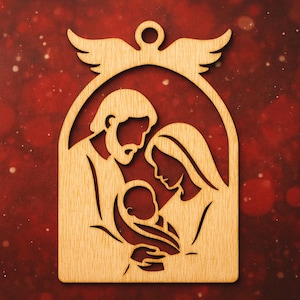 May include: Wooden Christmas decoration depicting the Nativity. The design shows Joseph, Mary, and baby Jesus, with an angel above. The ornament is made of light-coloured wood and has a cutout design.