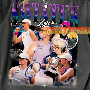 May include: Dark gray t-shirt featuring a graphic of Iga Swiatek, a tennis player, with the text "SWIATEK" in purple and blue. The design includes images of her playing tennis and holding a trophy.