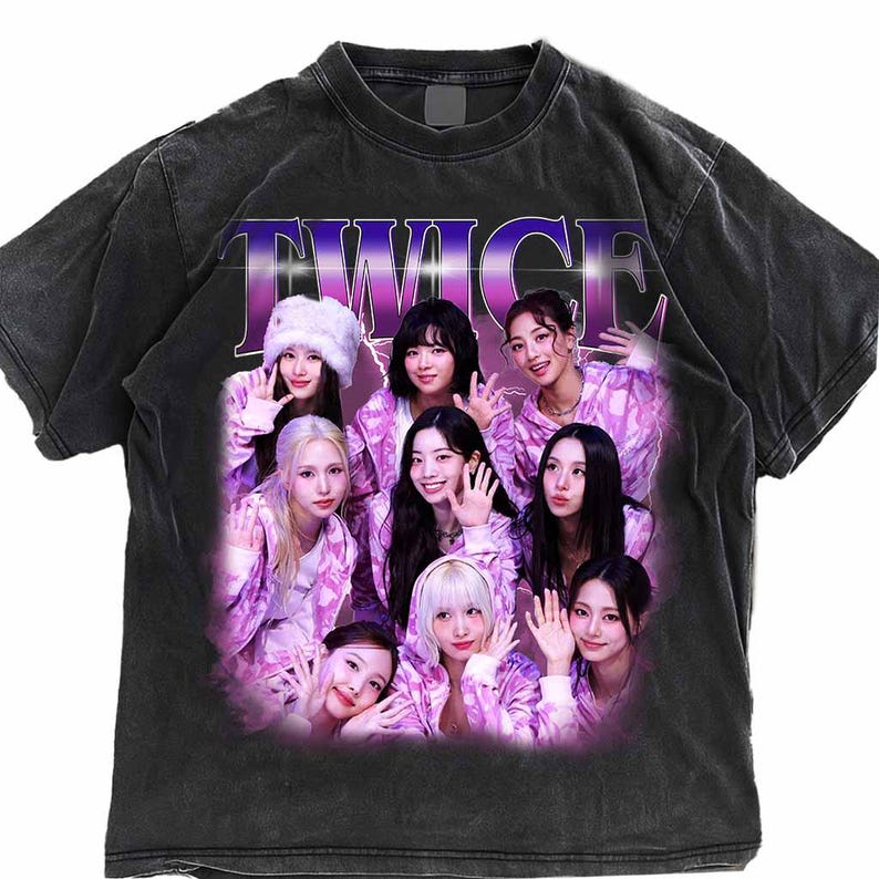 May include: Dark grey t-shirt with a graphic of nine people in pink and white clothing. The word "TWICE" is printed across the top in a purple and white gradient font. The t-shirt has a faded, vintage look.