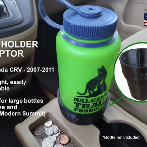 May include: A green Nalgene water bottle with a blue cap sits in a black cup holder adapter. The adapter is designed for Honda CRV models from 2007-2011. The text "CUP HOLDER ADAPTOR" and "Made in the USA" are visible.