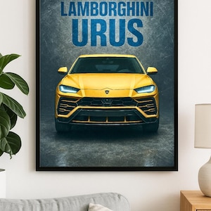 May include: Framed poster featuring a yellow Lamborghini Urus SUV. The car is centered, showcasing its front design with headlights and a black grille. The text "LAMBORGHINI URUS" is displayed in blue at the top. The poster is in a black frame.