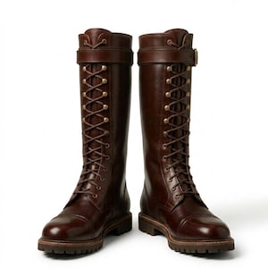 May include: A pair of dark brown leather knee-high boots featuring a front lace-up design with brass-toned eyelets, a buckled strap at the top, and a thick lug sole. The logo Morar Leather Gear is visible in the upper right corner of the image.