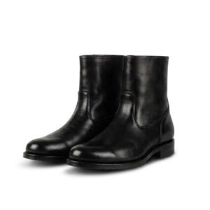 May include: A pair of black leather ankle boots with a smooth finish, rounded toes, and a low block heel. The boots feature a clean, structured design with visible stitching along the sides and a simple shaft that rises just above the ankle.