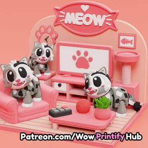 May include: A 3D printed pink cat-themed living room diorama featuring three gray and white spotted cat figurines, a pink sofa, a television with a paw print screen, a coffee table with a yarn ball, a plant, and a remote, with the text MEOW.