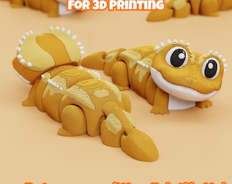 May include: Two articulated 3D printed bearded dragon figures in yellow and orange with white accents. The text DIGITAL DOWNLOAD FOR 3D PRINTING and Patreon.com/Wow Printify Hub is visible. The figures feature layered textures and large eyes.