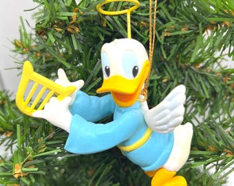 Anioł Kaczor Donald grający na żółtej harfie, świąteczna ozdoba kolekcjonerska Disney Grolier Vintage