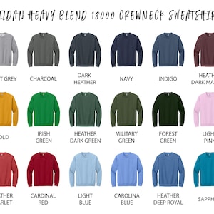 May include: A display of Gildan Heavy Blend 18000 crewneck sweatshirts in various colors, including white, black, navy, and red. The image shows the available colors with the name of each color below the sweatshirt.