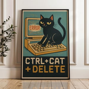 May include: A framed poster featuring a black cat sitting on a vintage beige computer keyboard. The computer screen displays the word ERROR in red text. Below the illustration, the text reads CTRL+CAT+DELETE in yellow, pixelated font.