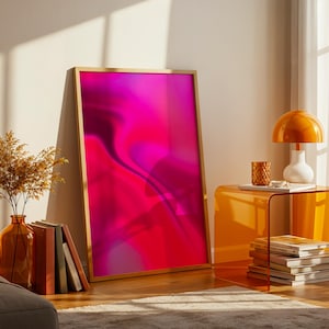 May include: A rectangular wall art print in a light wood frame featuring a vibrant, abstract gradient of hot pink, magenta, and deep red tones with fluid, swirling shapes that create a sense of depth and movement across the entire surface.