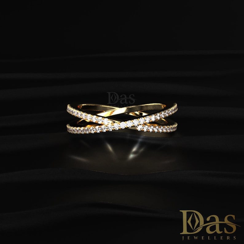 Luxury 14K yellow gold crossover ring featuring double crisscross bands lined with brilliant round moissanite stones for maximum sparkle and elegance. This modern stacking ring combines a refined open design with timeless diamond-inspired beauty, making it ideal as an anniversary ring, wedding jewelry, promise gift, or chic everyday accessory. The sleek intersecting bands and shimmering pavé moissanite details create a sophisticated and fashionable statement ring for women who love fine jewelry.