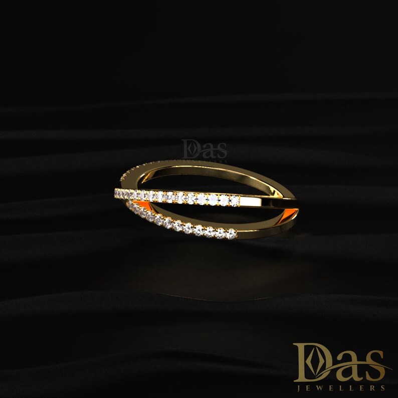 Modern crisscross diamond ring crafted in solid 14K yellow gold with shimmering round moissanite stones set along the crossover bands. This elegant bypass style ring combines minimalist beauty with luxury sparkle, making it perfect as a stacking ring, wedding band, anniversary gift, or trendy everyday jewelry. The sleek open crossover silhouette highlights contemporary elegance while the brilliant moissanite stones deliver exceptional shine and a refined designer-inspired look for stylish women.