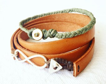 May include: Two bracelets, one brown leather and one green braided cord, with silver infinity and triangle charms.