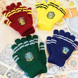 May include: Four pairs of knitted gloves in various colors: red with yellow stripes, yellow with black stripes, green with silver stripes, and blue with white stripes. Each pair features a crest emblem.