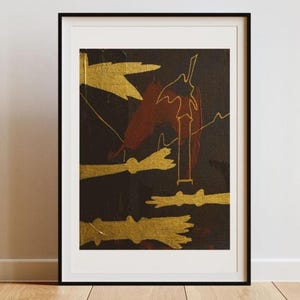 May include: Abstract art print in a black frame. The artwork features gold and maroon shapes on a dark background. The gold shapes appear to be brushstrokes or leaf-like forms. The maroon shapes are more geometric.