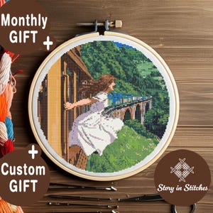 May include: A cross-stitch embroidery hoop featuring a scene of a woman in a white dress, with flowing brown hair, running towards a bridge. The background includes a train, green hills, and a wooden structure. Text includes "Monthly GIFT + Custom GIFT" and "Story in Stitches."