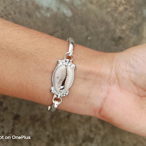 May include: A rustic wooden sign with the text "Welcome to our home" in white lettering. The sign has a distressed finish and a simple, inviting design, ideal for front door decor.