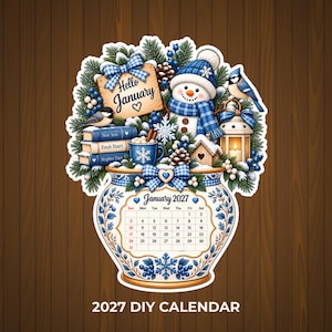May include: A decorative January 2027 calendar shaped like a vase, featuring a snowman, blue bird, pine branches, books labelled New Year, Fresh Start, and Brighter Days, a mug, and a lantern, with the text Hello January and 2027 DIY CALENDAR.