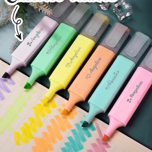 May include: Six pastel highlighters with clear lids, each marked "Angelica." The highlighters are on a notebook, each tip creating a different coloured stroke. The text "Custom name" is at the top.