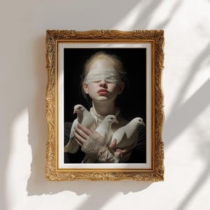 May include: A framed art print featuring a person with a blindfold holding three white doves. The artwork is set against a dark background and framed in an ornate gold frame. The person's skin is pale, and the doves are pristine white.