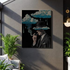 May include: A framed art print depicts a man in a suit and bowler hat smoking a pipe, with a cloud obscuring his face. The artwork features blue clouds and raindrops against a black background, creating a surreal and artistic aesthetic.