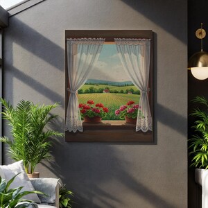 Puede incluir: Impresión en lienzo enmarcada que representa una vista panorámica a través de una ventana. La ventana revela un paisaje con campos, casas y colinas bajo un cielo azul. Geranios rojos en macetas adornan el alféizar, enmarcados por cortinas de encaje blanco.