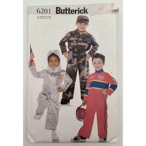 May include: Butterick sewing pattern 6201 featuring three costume designs: a silver quilted space suit with a hood and American flag patch, a camouflage jumpsuit with a matching cap, and a red racing jumpsuit with blue and yellow stripes and STP logo.