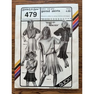 May include: A white sewing pattern envelope for Stretch & Sew gored skirts, pattern 479. The front features black and white illustrations of four different skirt styles labeled View A, B, C, and D, with text including Make-It-In-Minutes and Quick.