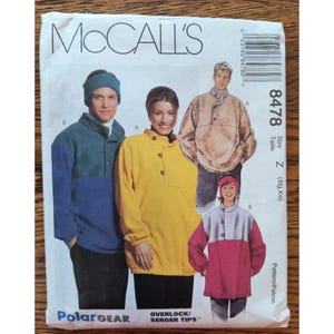 May include: A McCall's 8478 sewing pattern envelope for PolarGear fleece pullovers and headbands. The cover displays illustrations of four individuals wearing various color-blocked fleece tops and headbands with button-front details.