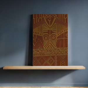 May include: A rectangular, abstract artwork with a reddish-brown background and gold-colored geometric patterns. The artwork is displayed on a light-colored wooden shelf against a dark blue wall. The design features shapes like circles, triangles, and lines.