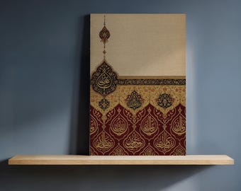 以下が含まれることがあります： 深紅とベージュの背景に金色の装飾的なアラビア書道が施された、キャンバスアートプリント。 このアートワークは、青い壁を背景にした木製の棚に展示されており、伝統的と現代的な美学を融合させています。