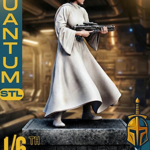 May include: A detailed 1/6 scale figure of a character from a science fiction film, holding a blaster. The figure is dressed in a long, flowing white gown and has a distinctive hairstyle. The figure is standing on a stone-like base. The text "QUANTUM STL" and "SCULPS" are visible.
