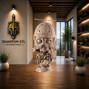 May include: A detailed, light-coloured sculpture of a skull wearing a helmet with a propeller. The skull has visible teeth and a skeletal torso. The sculpture is on a wooden surface. The background includes a logo that says "QUANTUM STL 3D DESIGN STUDIO".