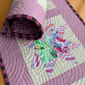 Handmade quilted one of a kind table runner..modern patchwork star design in purple and floral prints. Cottagecore or boho table decor.