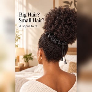 May include: A black satin hair accessory with an adjustable drawstring and toggle closure, worn around a high bun. The text on the image reads: Big Hair? Small Hair? Just pull to fit. The accessory features a smooth, gathered fabric texture.