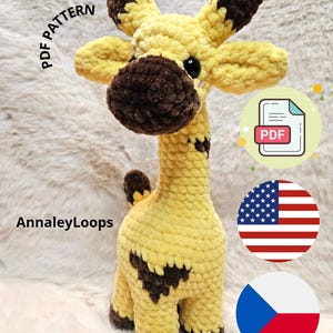 May include: A handmade, plush giraffe in yellow and brown. The giraffe has dark brown spots and accents on its ears, nose, and hooves. The image includes the text "PDF PATTERN" and "AnnaleyLoops".