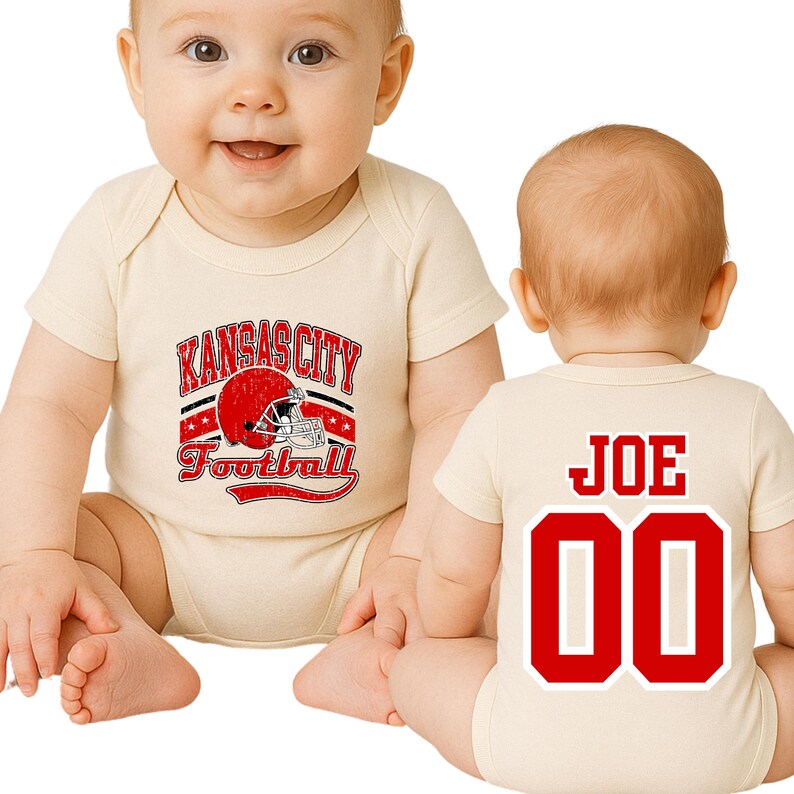 A baby wearing a white onesie with a Kansas City football team logo and the name "Joe" printed on the back.