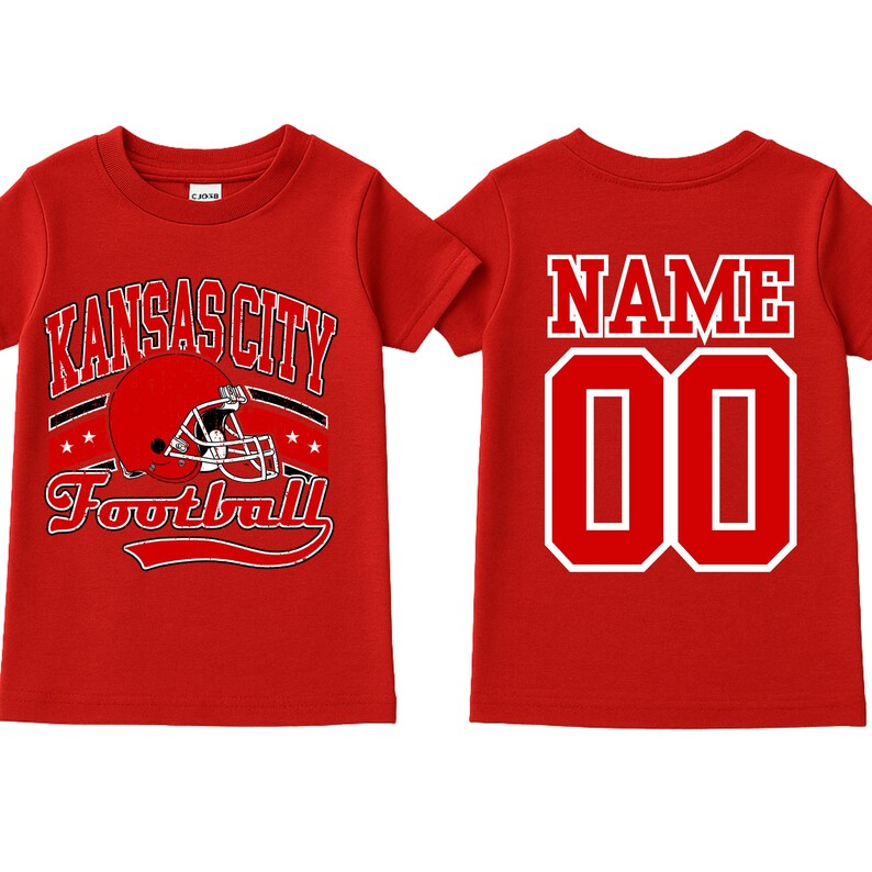 A red t-shirt with the text "KANSAS CITY FOOTBALL" printed on it, along with a football helmet graphic. The t-shirt also has the number "00" printed on the back.