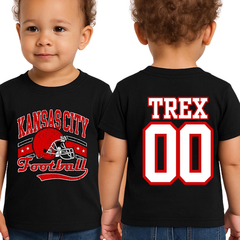 A young child wearing a black t-shirt with a Kansas City football design and the name "TREX" printed on the back.