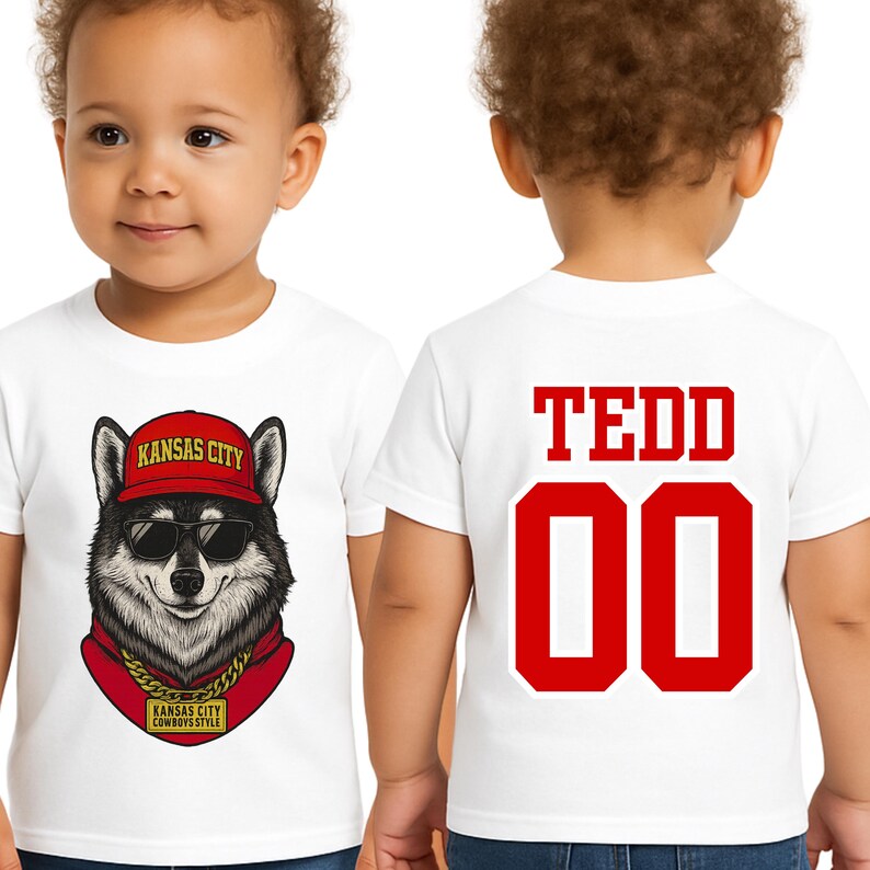 A white t-shirt with a graphic of a wolf wearing sunglasses and a red bandana, along with the text "KANSAS CITY" and "KANSAS CITY WORKS STYLE". The back of the t-shirt has the name "TEDD" and the number "00" printed on it.